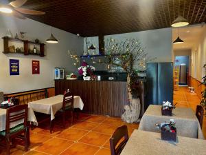 a restaurant with tables and chairs and a counter at Tam Coc Mountain View Homestay in Ninh Binh