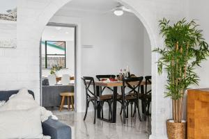 a living room with a dining room table with chairs at Coastal Blue in Windang