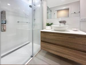 a bathroom with a sink and a shower at 180 Degrees - Amazing Bay Views in St Helens +40 photos