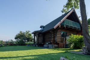 a log cabin with a gambrel roof at Forest Villa Rio Biwako in Takashima
