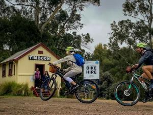 two people riding bikes down a dirt road at Riverview Coastal Retreat Sleeps 6 Walk to Beach Great Ocean Road in Peterborough
