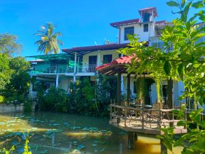 a house with a pond in front of it at Haritha Villa Yala in Kirinda