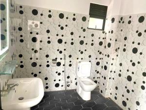 a bathroom with a toilet and a sink at Haritha Villa Yala in Kirinda +30 photos