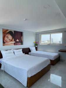 two beds in a bedroom with a large window at Hồng Phúc 7 Hotel in Danang +15 photos
