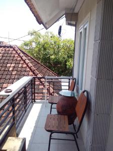 a patio with two chairs and a table on a balcony at NEW KUBU DI BUKIT apartemen & motor bike rental in Jimbaran