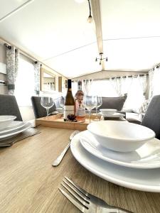a table with white plates and forks and wine glasses at Cedar Retreat in Scarborough
