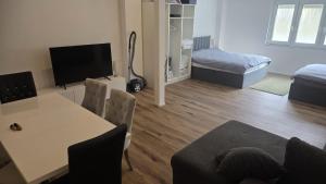 a living room with a table and a couch at Spacious Apartment for 8 Guests in Tuttlingen