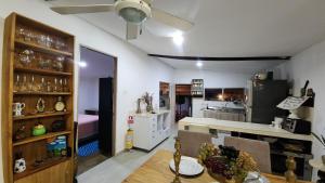 a kitchen and dining room with a table and a room with a kitchen at Casa de Playa Salgar in Puerto Colombia