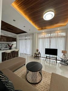 a living room with a couch and a television at Casa Marcos Resort and Villas in Pastrana