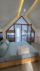 a bedroom with a bed with three towels on it at Casa Marcos Resort and Villas in Pastrana +52 photos