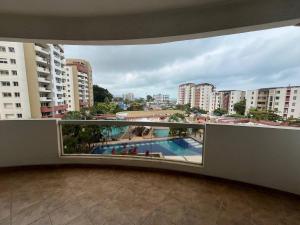 a balcony with a view of a pool and buildings at Playa Almendro Resort in Tonsupa