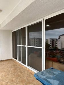a room with a large window with a view of a city at Playa Almendro Resort in Tonsupa