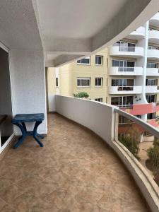 a balcony with a blue bench and a building at Playa Almendro Resort in Tonsupa