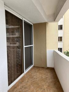 an empty balcony with a large window in a building at Playa Almendro Resort in Tonsupa