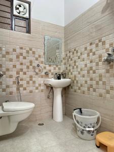 a bathroom with a sink and a toilet and a sink at Nasadra villa in Jaipur +12 photos