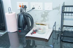 a kitchen counter with a coffee maker and a blender at Hise Haven Stays in Kiambu