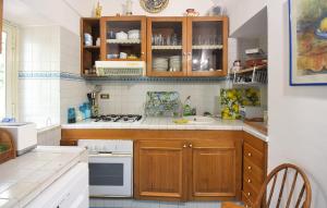 a kitchen with wooden cabinets and a stove top oven at Villa Marina in Anacapri