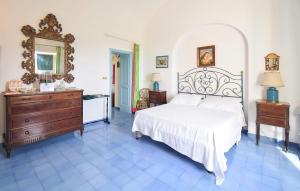 a bedroom with a bed and a dresser and mirror at Villa Marina in Anacapri