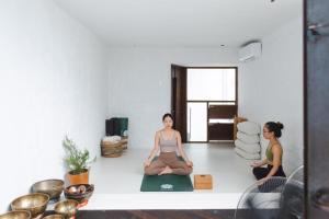 two women sitting in a room practicing yoga at The Still Slow & Sip in Nha Trang