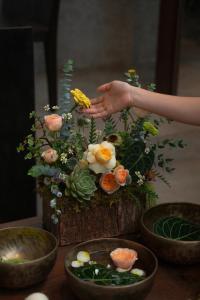 a table with a vase with flowers on it at The Still Slow & Sip in Nha Trang +22 photos