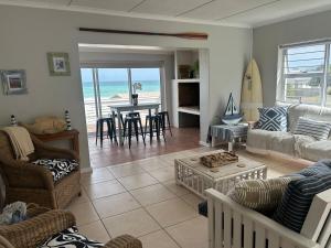 a living room with a view of the beach at Blue-breaker view in Struisbaai