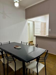 a black table and chairs in a room at Departamento Lavanda in San Juan +2 photos
