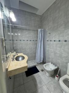 a bathroom with a sink and a toilet at Departamento Lavanda in San Juan
