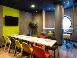 a conference room with a table and chairs at ibis budget Bordeaux Centre - Gare Saint Jean in Bordeaux