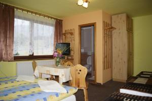 a bedroom with a bed and a table and a room at Privat u Babky in Ždiar