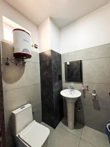 a bathroom with a toilet and a sink at Dual Lake in Bhīm Tāl