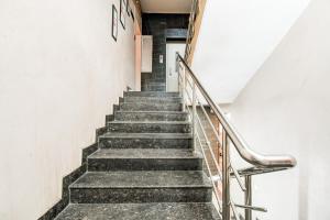 a staircase in a building with a stair case at Hotel O Raipur City Center Formerly South Inn in Raipur