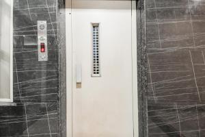 a white door with a window in a room at Hotel O Raipur City Center Formerly South Inn in Raipur