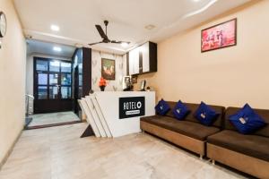 a living room with a couch and a table at Hotel O Raipur City Center Formerly South Inn in Raipur +31 photos