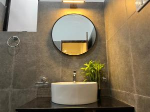 a bathroom with a sink and a mirror at AB Villa in Hikkaduwa