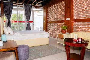 a bedroom with a bed and a brick wall at Lamatar Hills Resort in Pātan