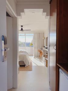 a bedroom with a bed and a large window at Hillcrest Merimbula in Merimbula
