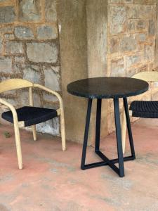 a black table and two chairs and a table and a chair at Annabelle's Cottage in Clare