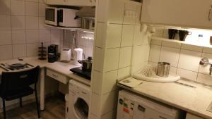 a small kitchen with a washing machine in it at Apartment Patrícia with garden in Budapest