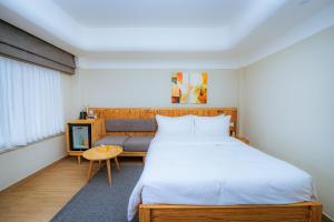 a bedroom with a large bed and a table at 31 Park Hotel in Pokhara