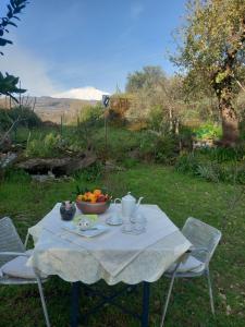a table with a bowl of fruit on it at Riccioli dell' Etna in Piedimonte Etneo