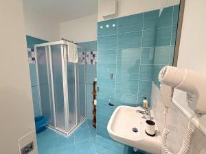 a bathroom with a shower and a white sink at Coco'S Rooms in Bari Palese +69 photos