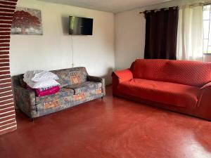 a living room with a couch and a chair at Casa de campo en Zacatlán in Zacatlán