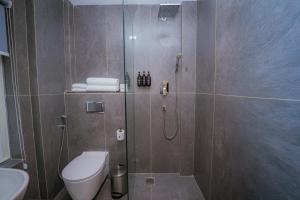 a bathroom with a shower with a toilet and a sink at 31 Park Hotel in Pokhara +18 photos