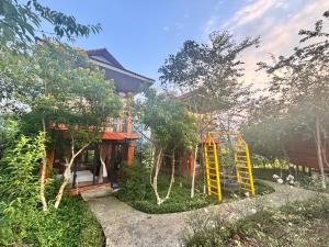 a house with a playground in front of it at Love hill than Uyên in Bản Kiem