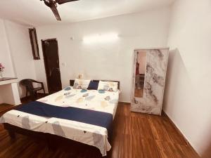 a bedroom with a bed and a mirror in it at BTS STAY- Singh Niwas in Ghaziabad