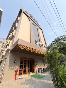 a building with a sign on the side of it at Hotel Avenue Inn in Navi Mumbai