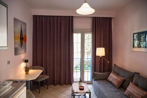 a living room with a couch and a table at Cretan Dawn Apart, Value Option in Ammoudara in Ayía Marína