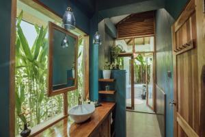 a bathroom with a sink and a mirror at Marevka - Pool Villa with garden in General Luna +15 photos