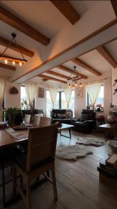 a large living room with a table and chairs at Casa de Sub Munte Cozy Chalet in Fundata