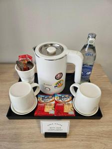 a tray with a coffee maker and cups on a table at Sena House in Bangkok